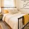 Model bedroom at our apartments for rent in NoDa, Charlotte, with Queen Size Bed and Accent Table and Lamp.